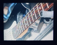 a black and white photo of a guitar